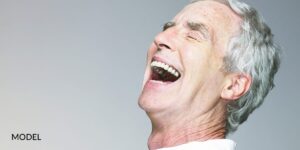 Older men laughing with his mouth wide open